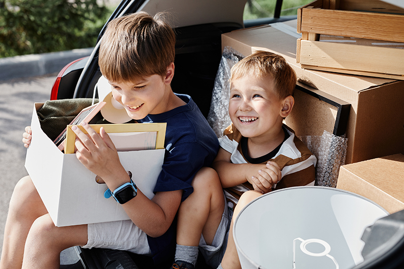 Two Smiling Boys Moving House